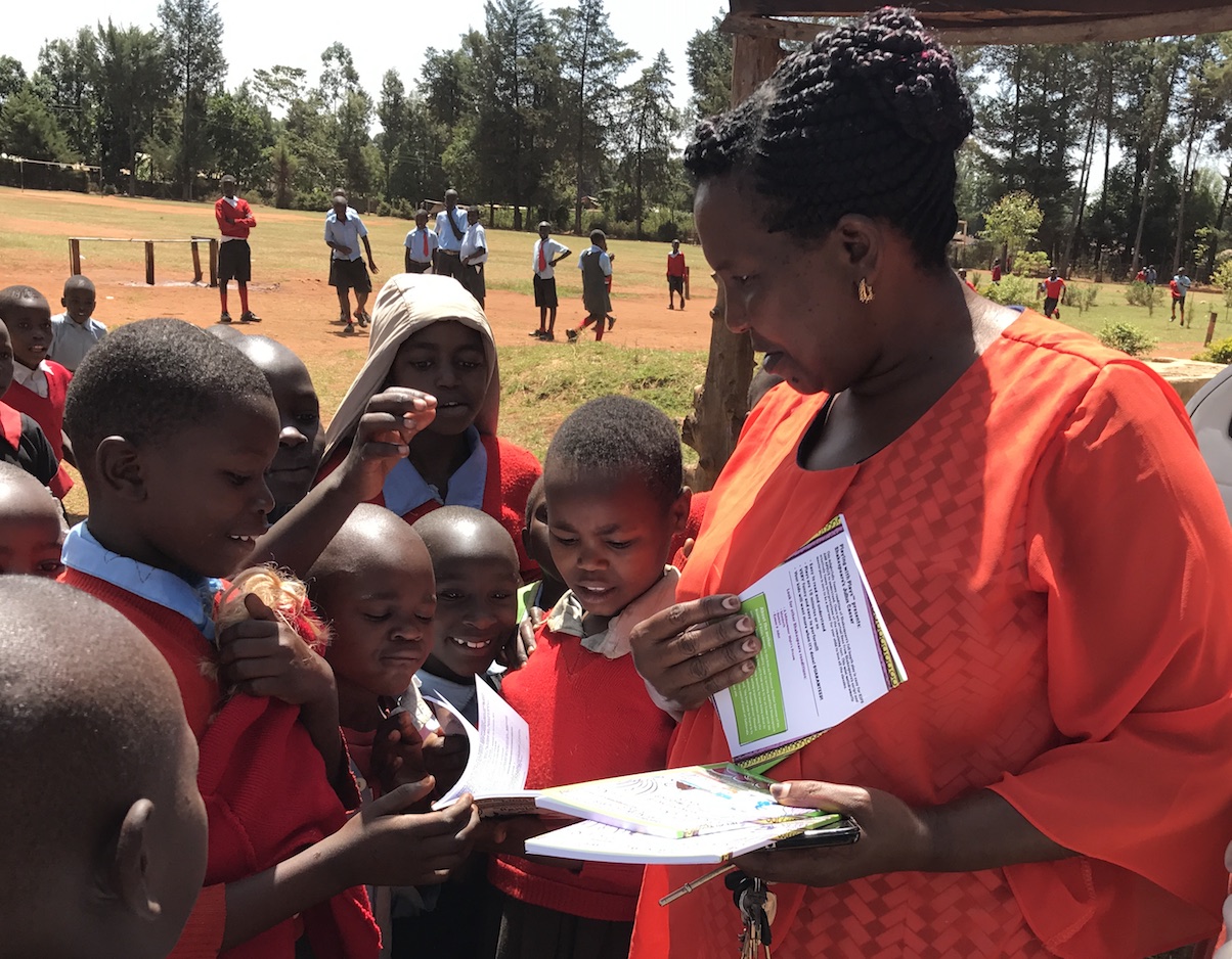 Teacher passing out Shakespeare for Kids books